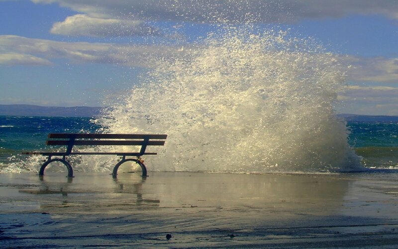 Bench hit by ocean wave