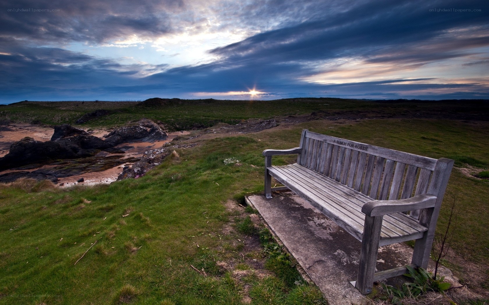 Bench overlooking coastal sunset