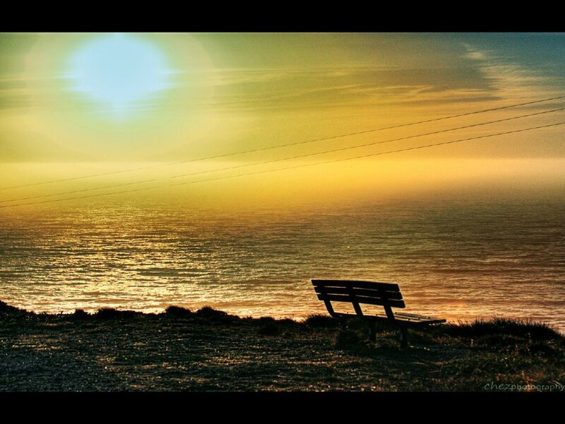 Bench overlooking the ocean at sunset