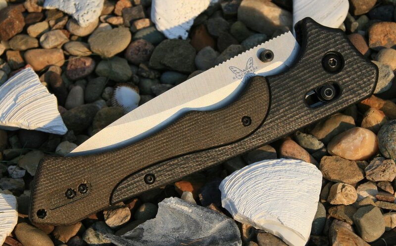 Benchmade folding knife on pebbles