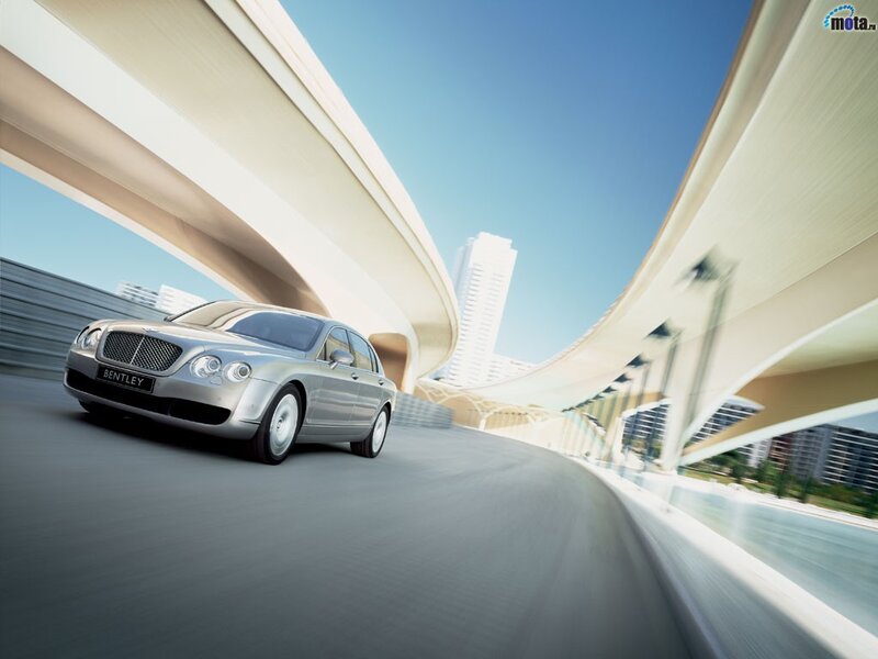 Bentley driving on a curved highway