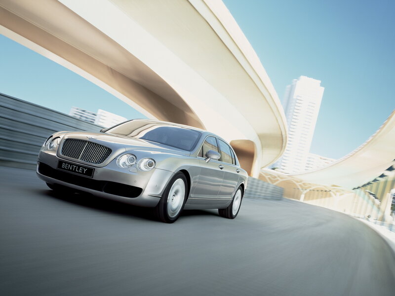 Bentley driving on a curved road