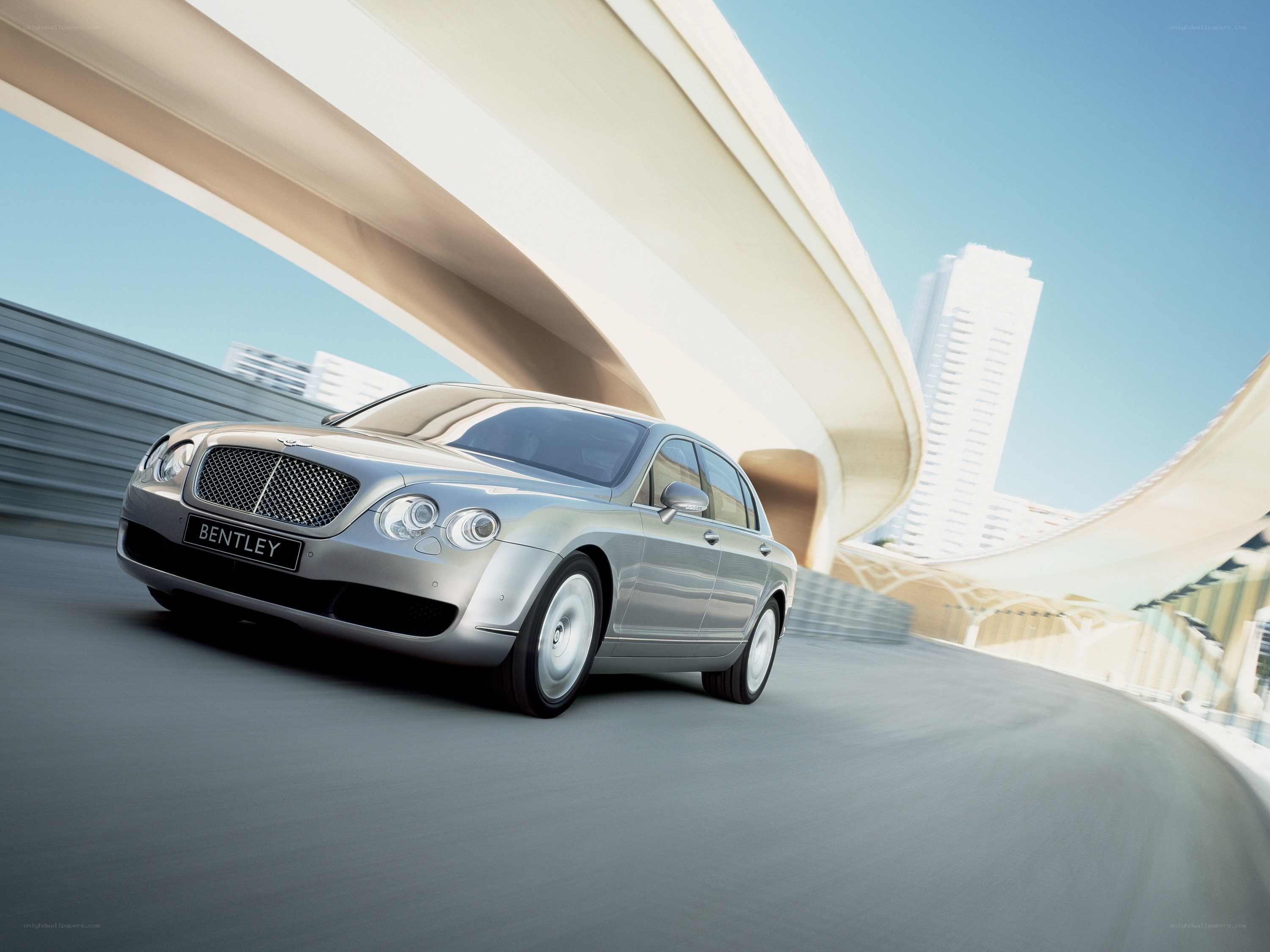 Bentley driving on a curved road