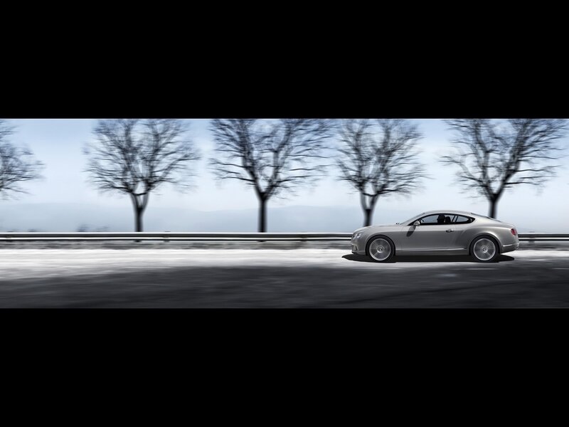 Bentley driving on a road
