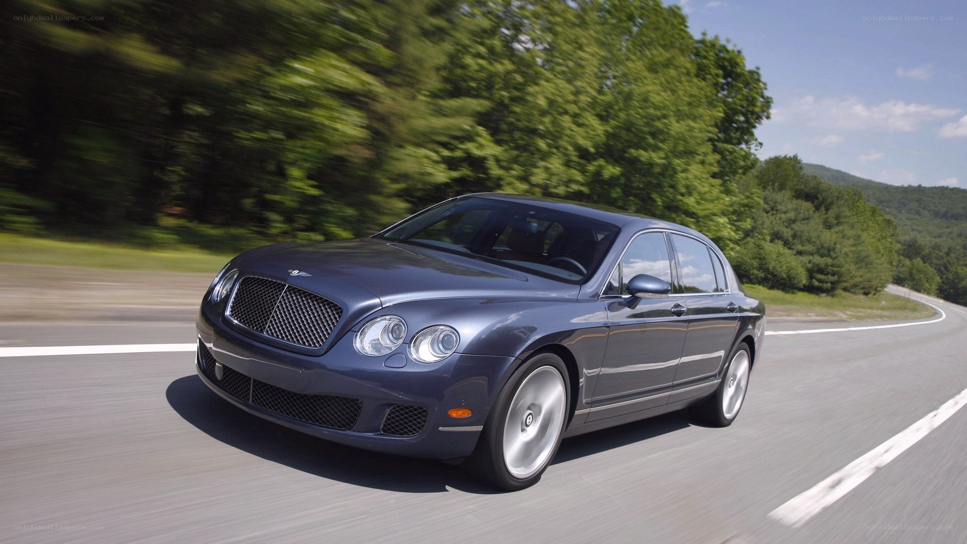 Bentley driving on a road
