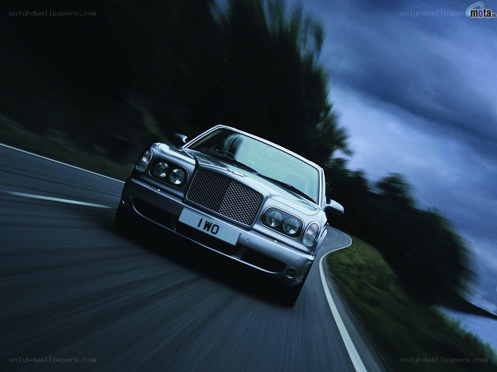 Bentley driving on a road