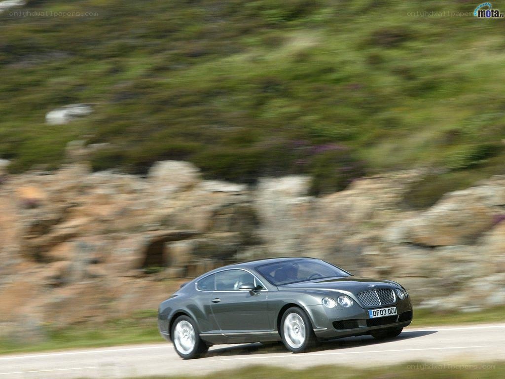 Bentley driving on a road