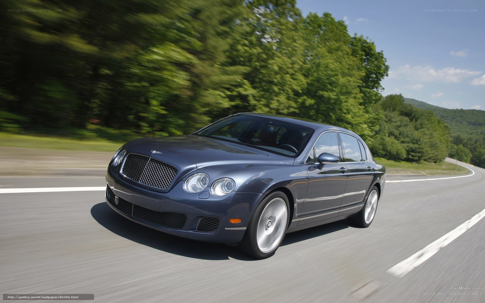 Bentley driving on a road