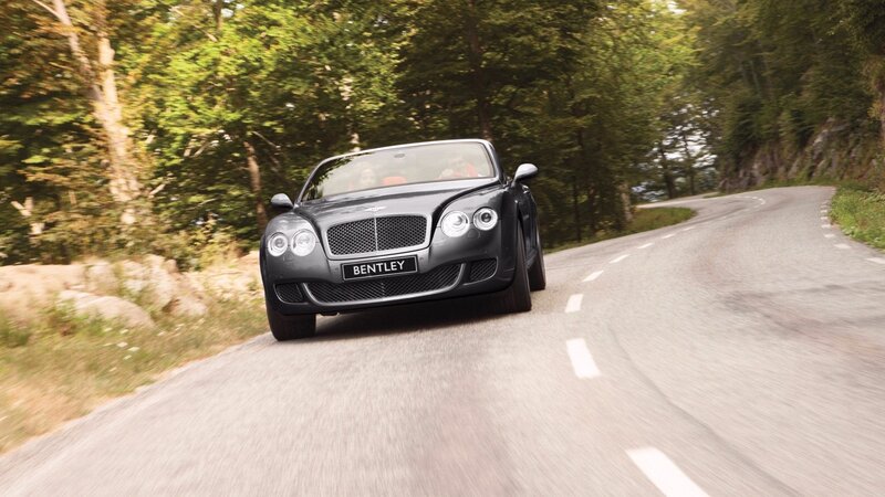 Bentley driving on a winding road