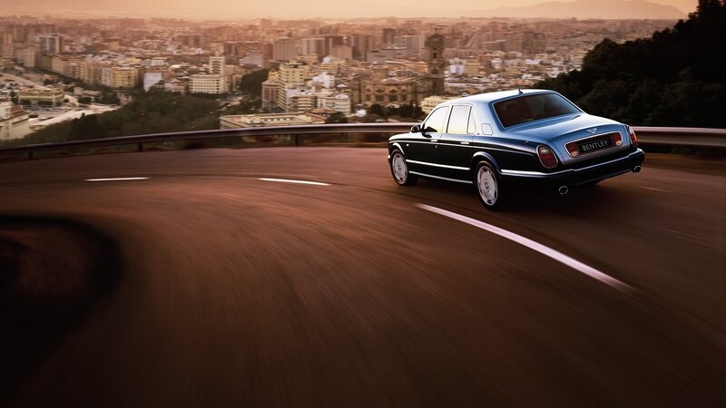Bentley driving on a winding road