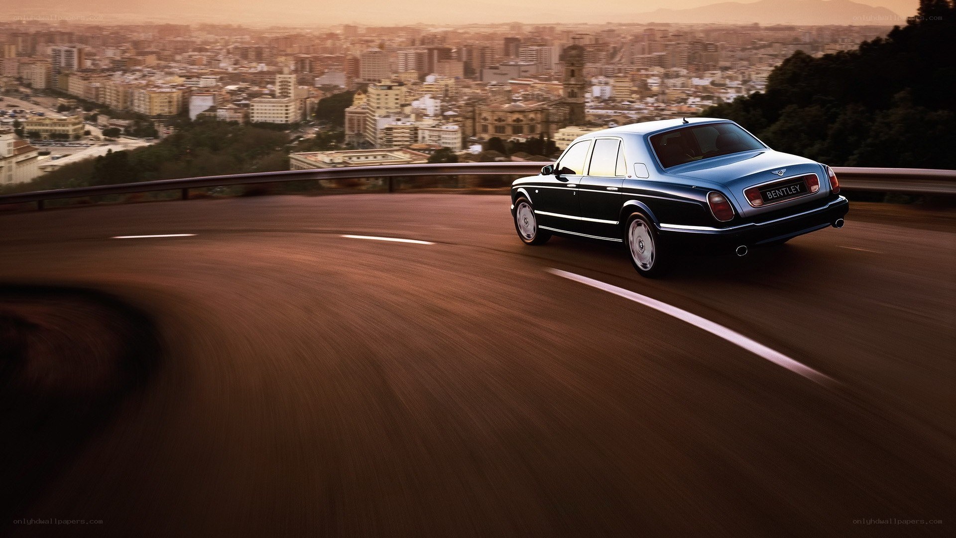 Bentley driving on a winding road