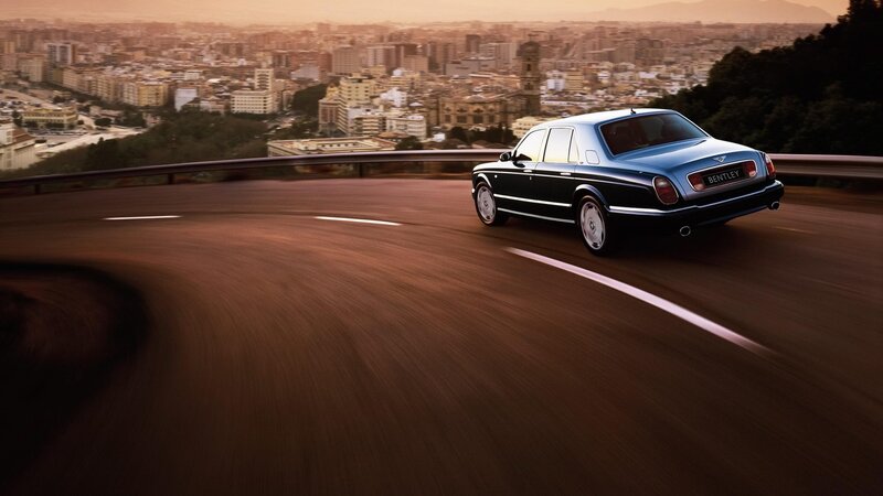 Bentley driving on a winding road