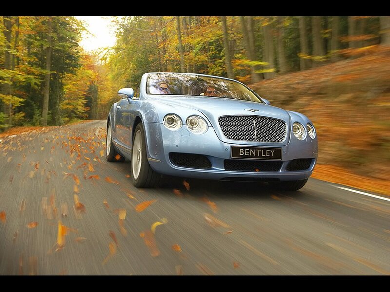 Bentley driving on autumn road