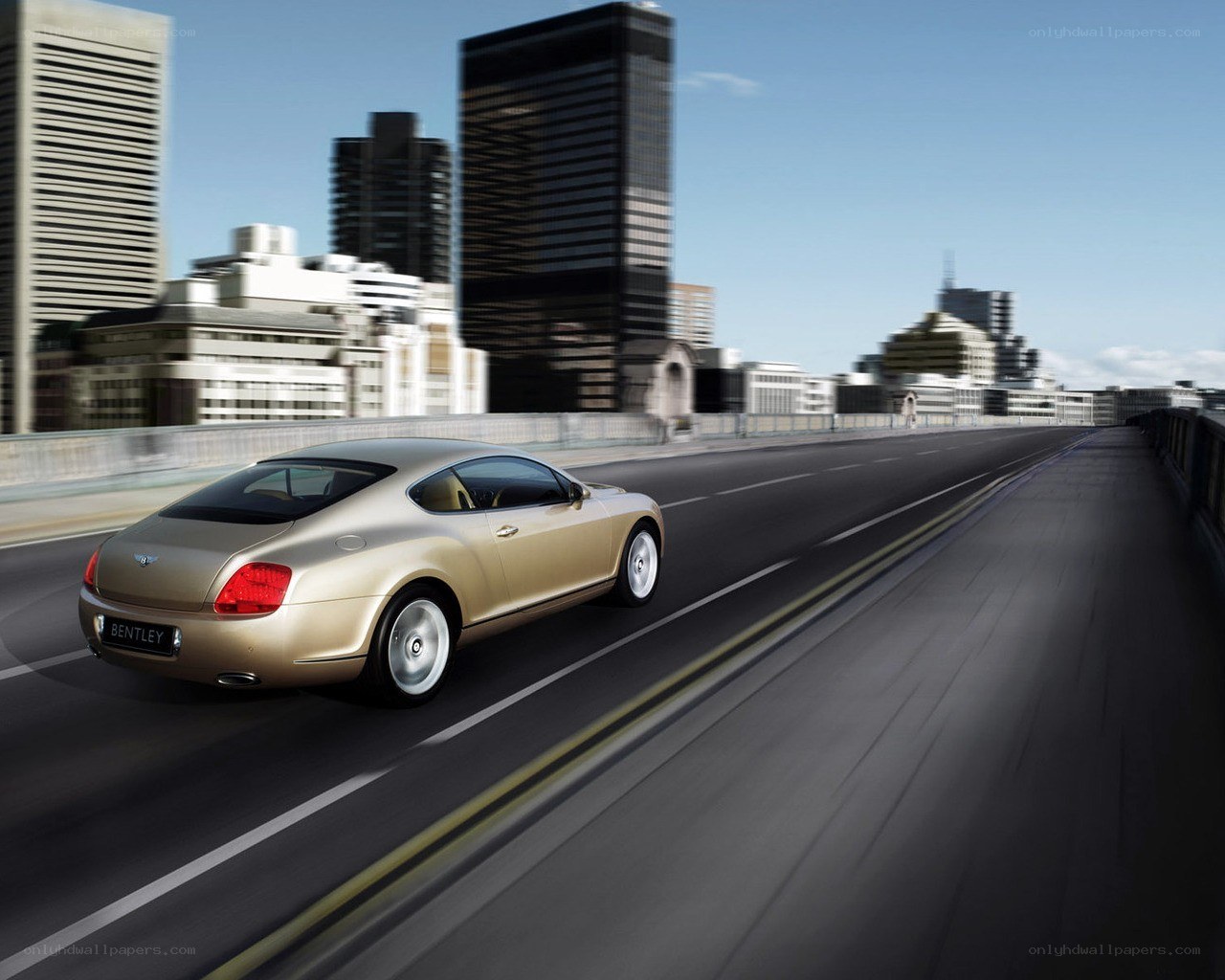 Bentley driving on city bridge