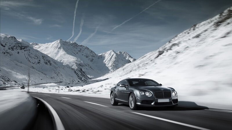 Bentley driving on snowy mountain road