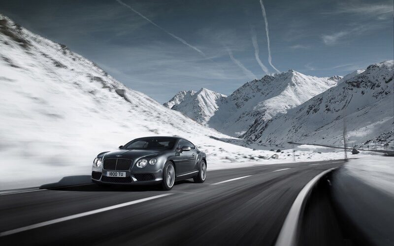 Bentley driving on snowy mountain road