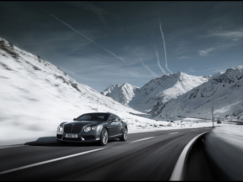 Bentley driving on snowy mountain road