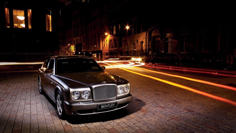 Bentley on a city street at night