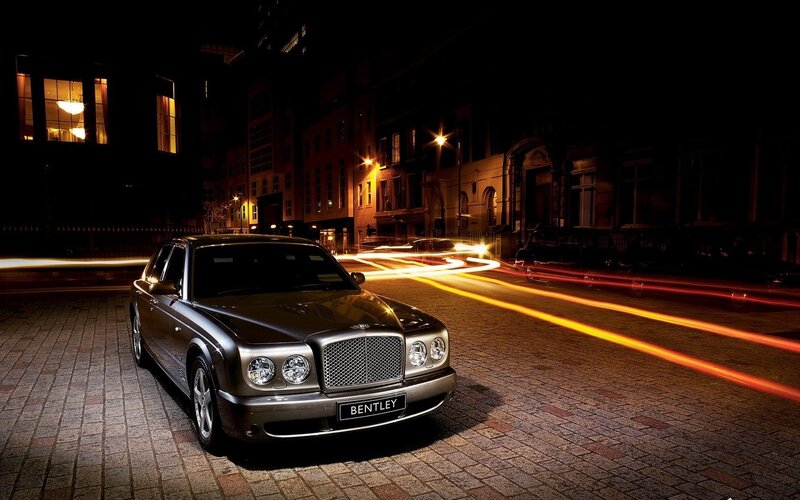 Bentley on a city street at night