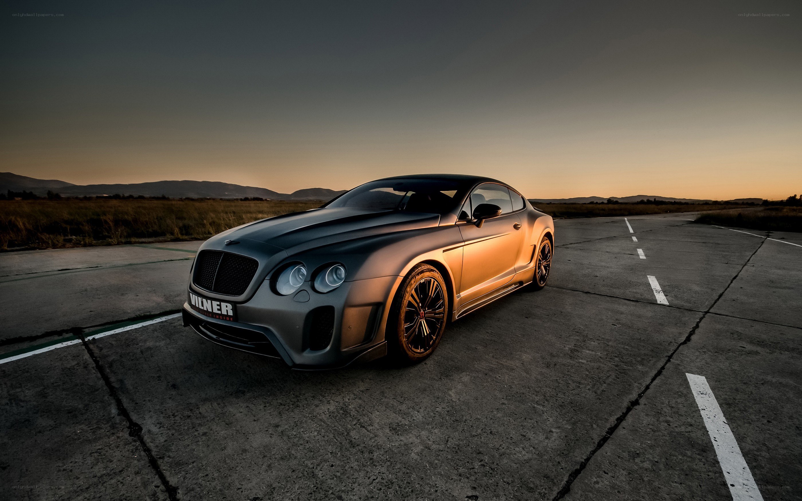 Bentley on a runway at sunset