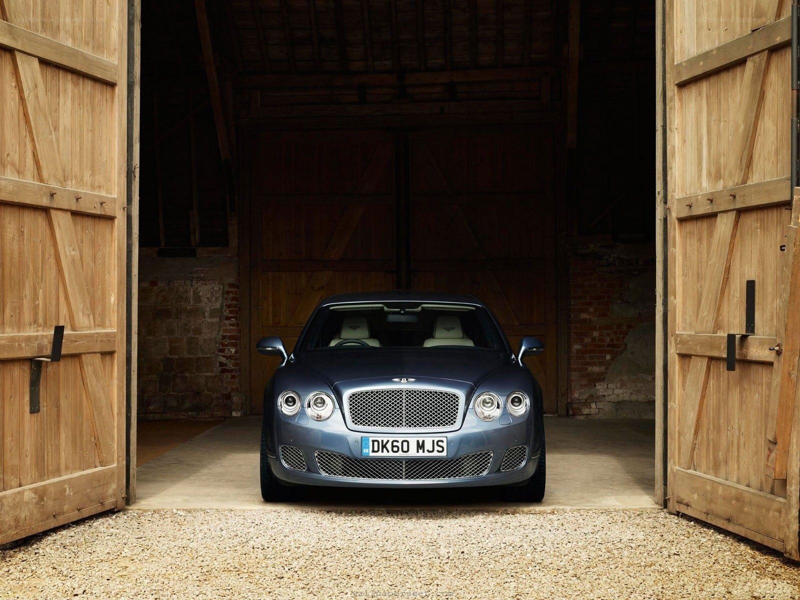 Bentley parked in a barn