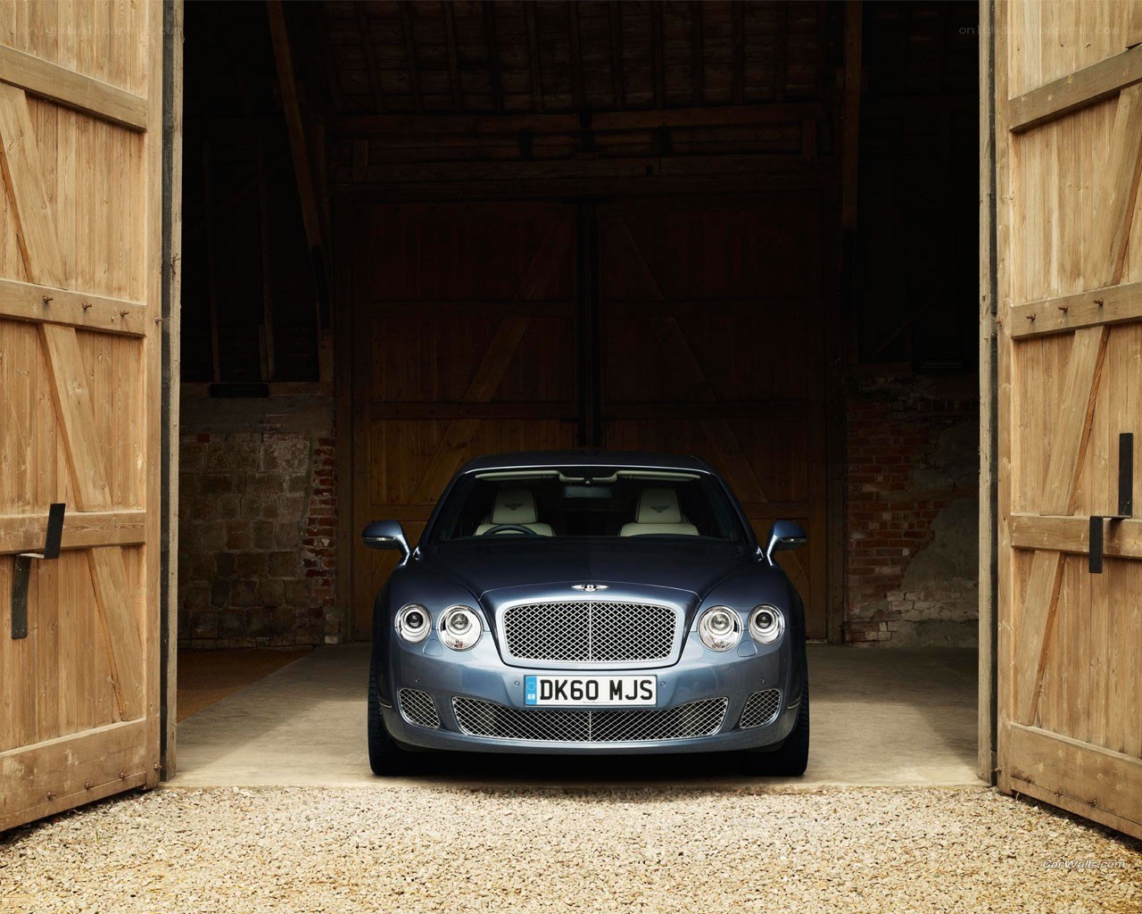 Bentley parked in a barn