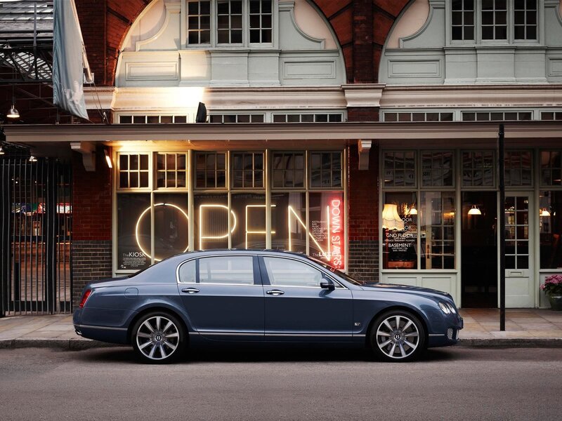 Bentley parked in front of a shop