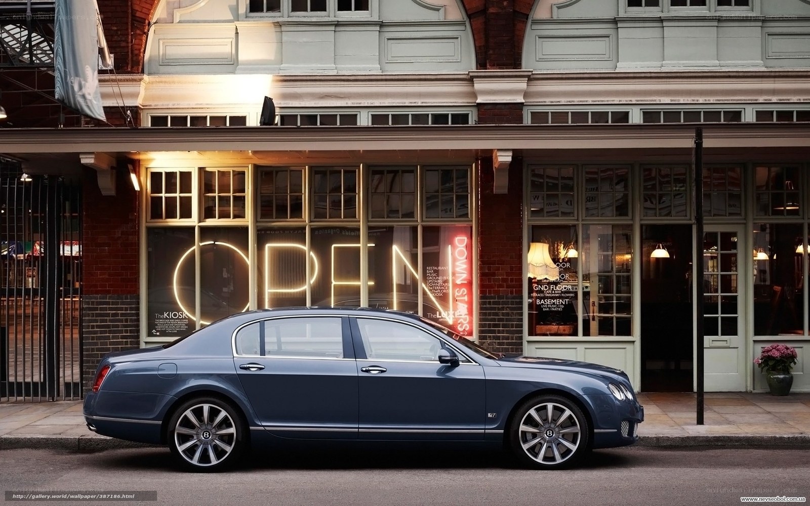 Bentley parked in front of a shop
