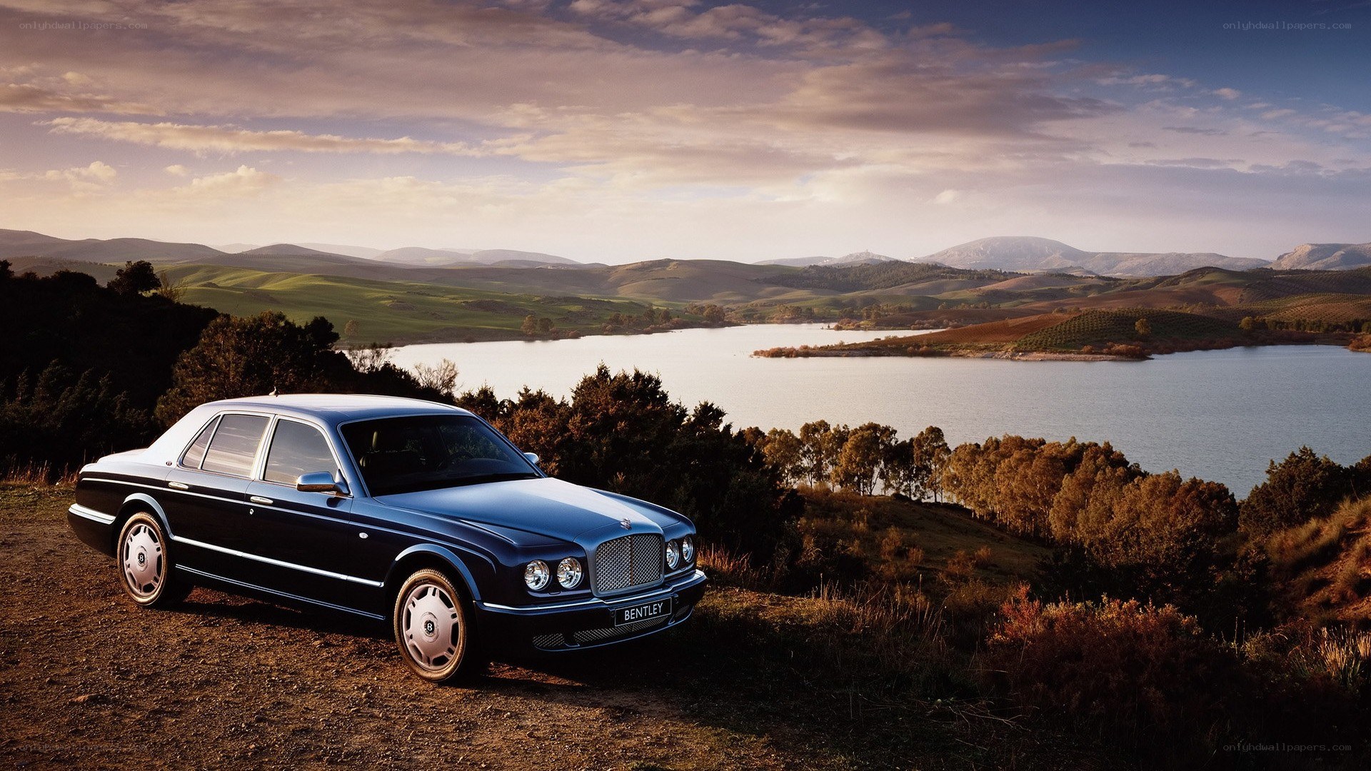 Bentley sedan by a lake