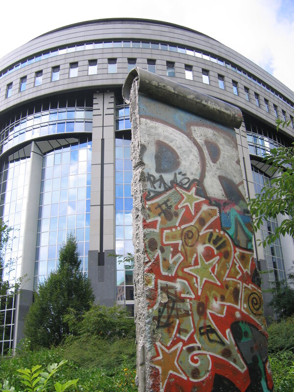 Berlin Wall fragment in front of modern building