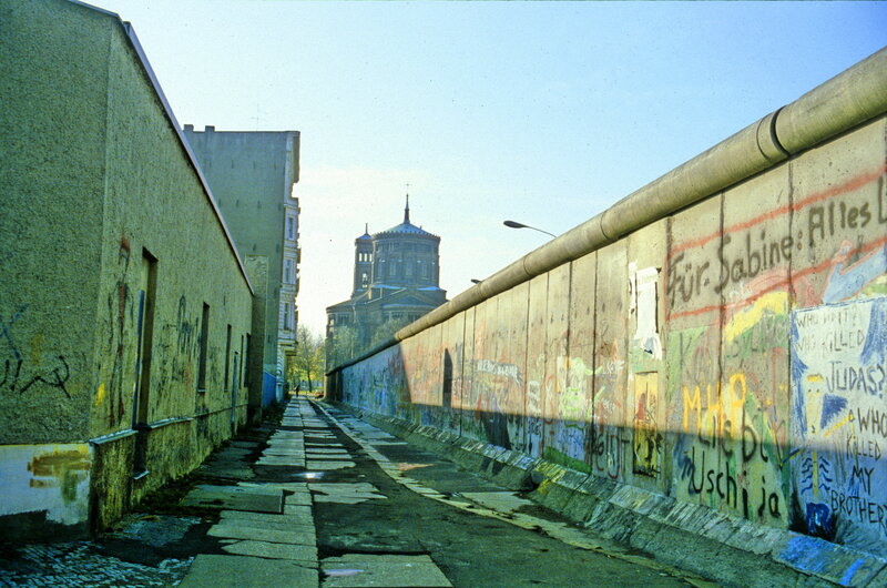 Berlin Wall with graffiti and church