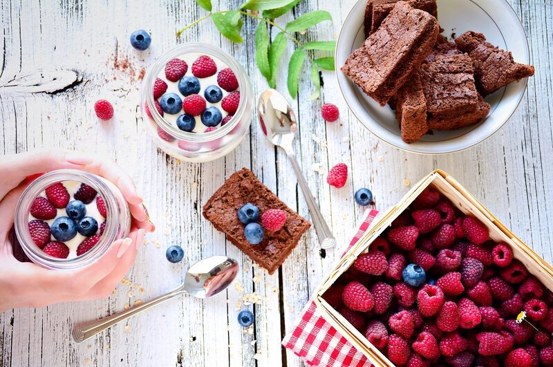 Berries and brownies on wood