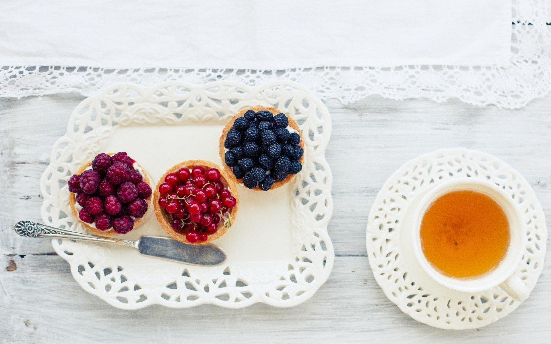 Berry tarts and tea on a tray