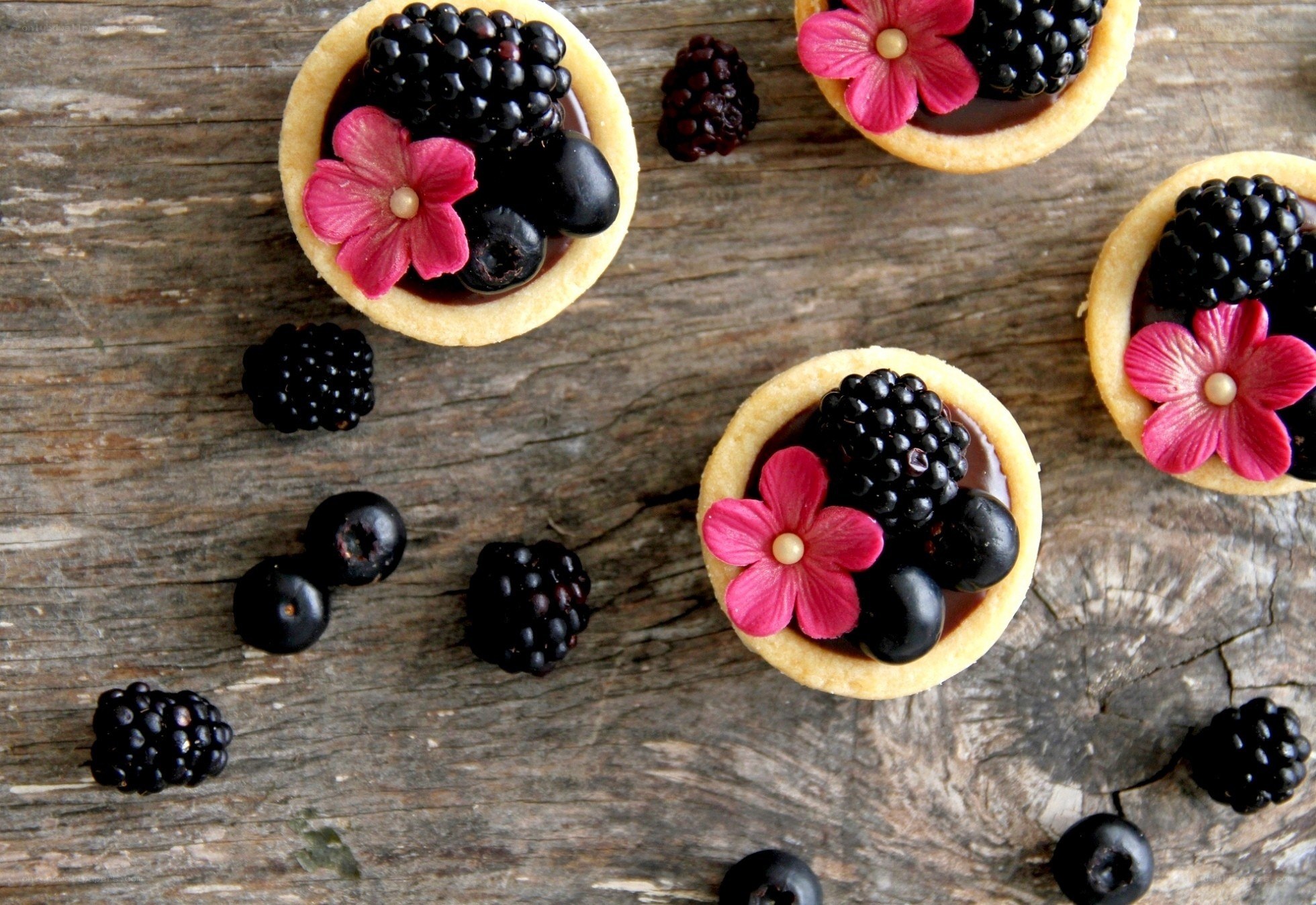 Berry tarts with edible flowers