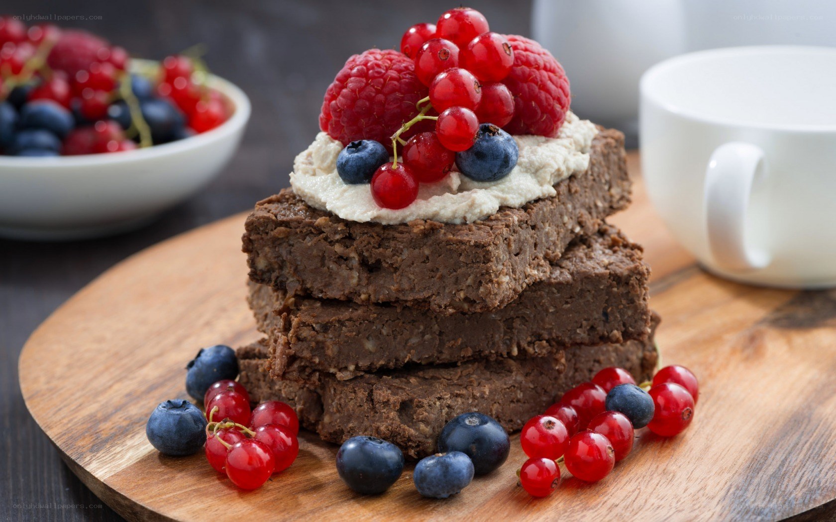 Berry-topped brownies on wood