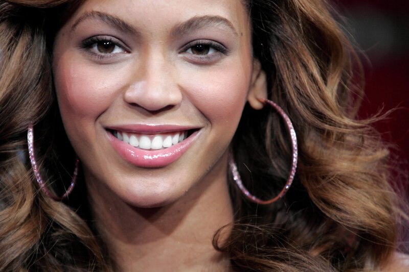 Beyoncé smiling with hoop earrings