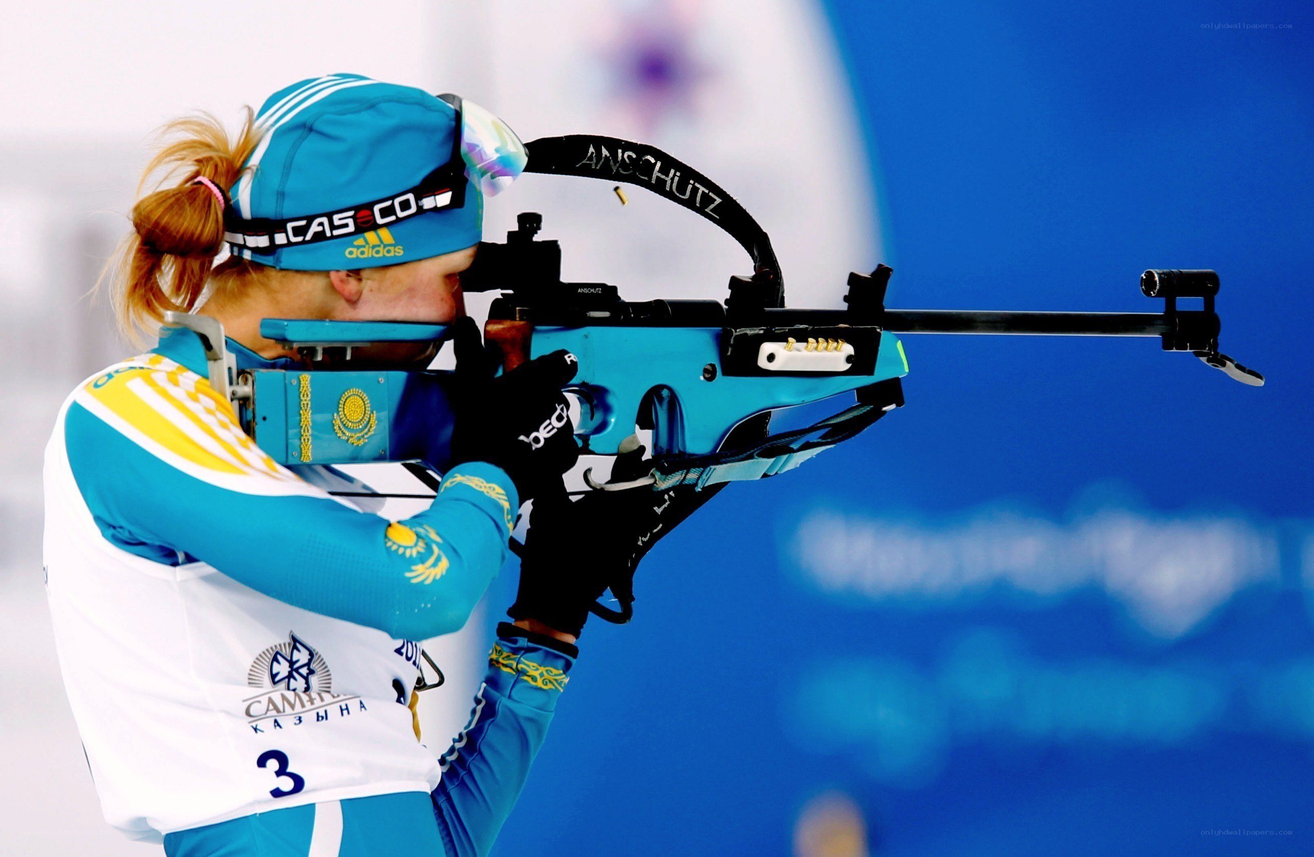 Biathlete aiming rifle