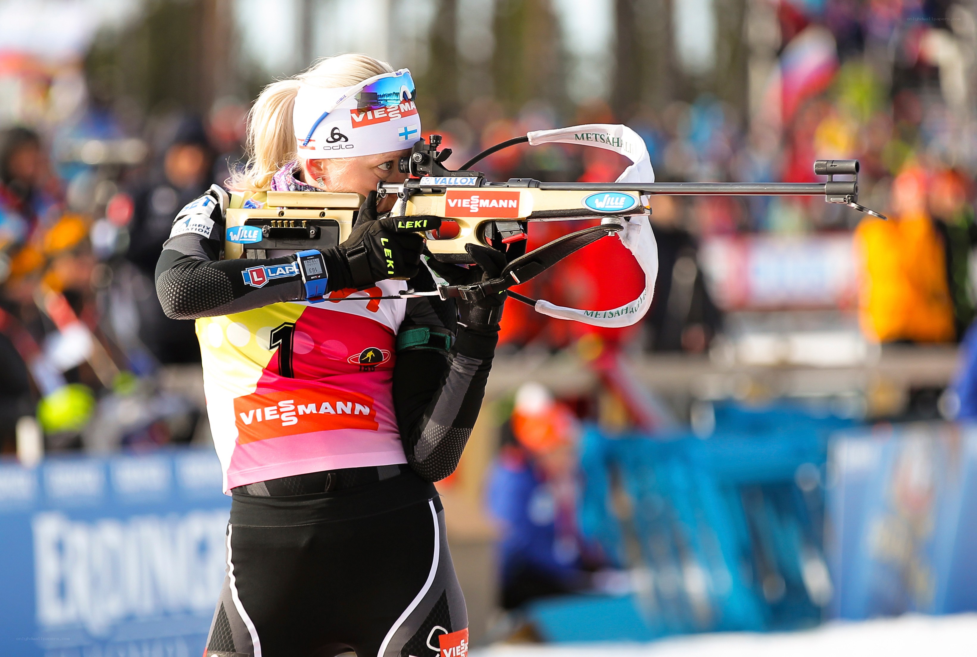 Biathlete aiming rifle