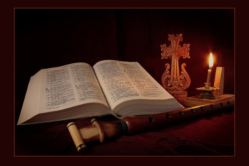 Bible and candle on table