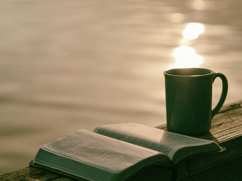 Bible and coffee by the water