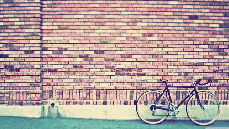 bicycle against brick wall