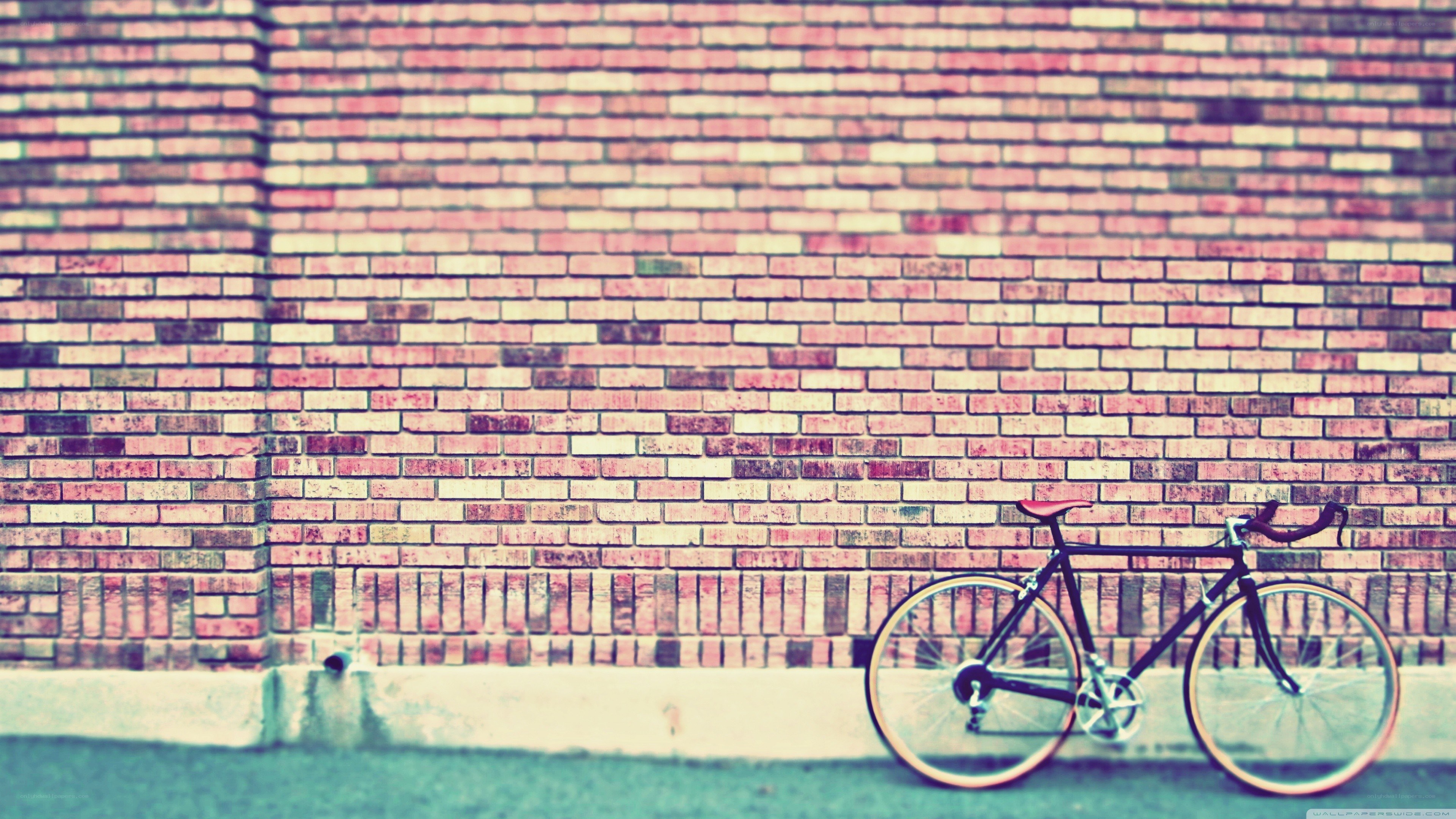 bicycle against brick wall