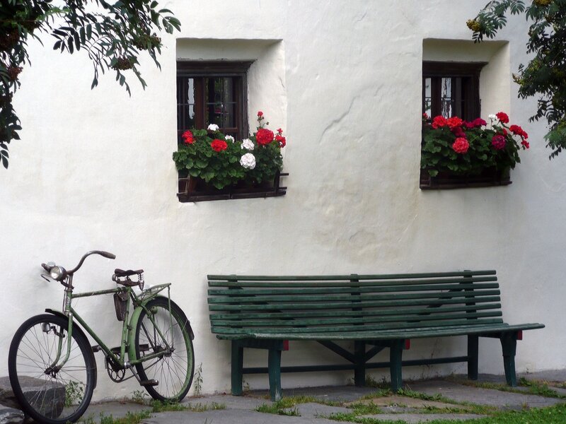 Bicycle and bench by flower boxes