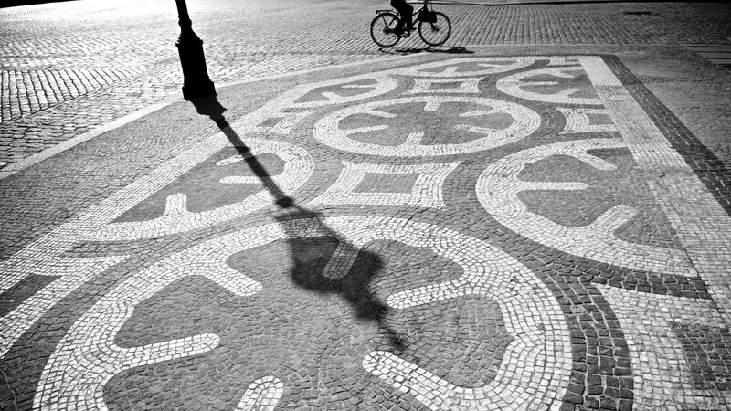 Bicycle and shadow on mosaic pavement