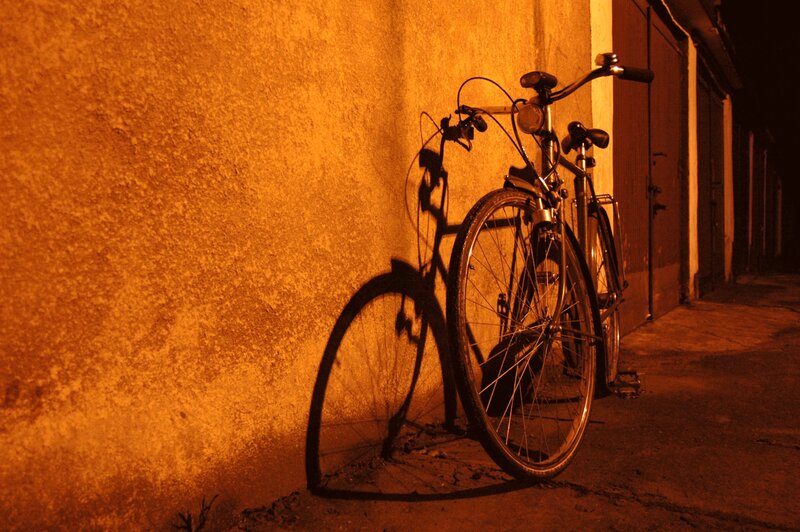 Bicycle at night against a wall