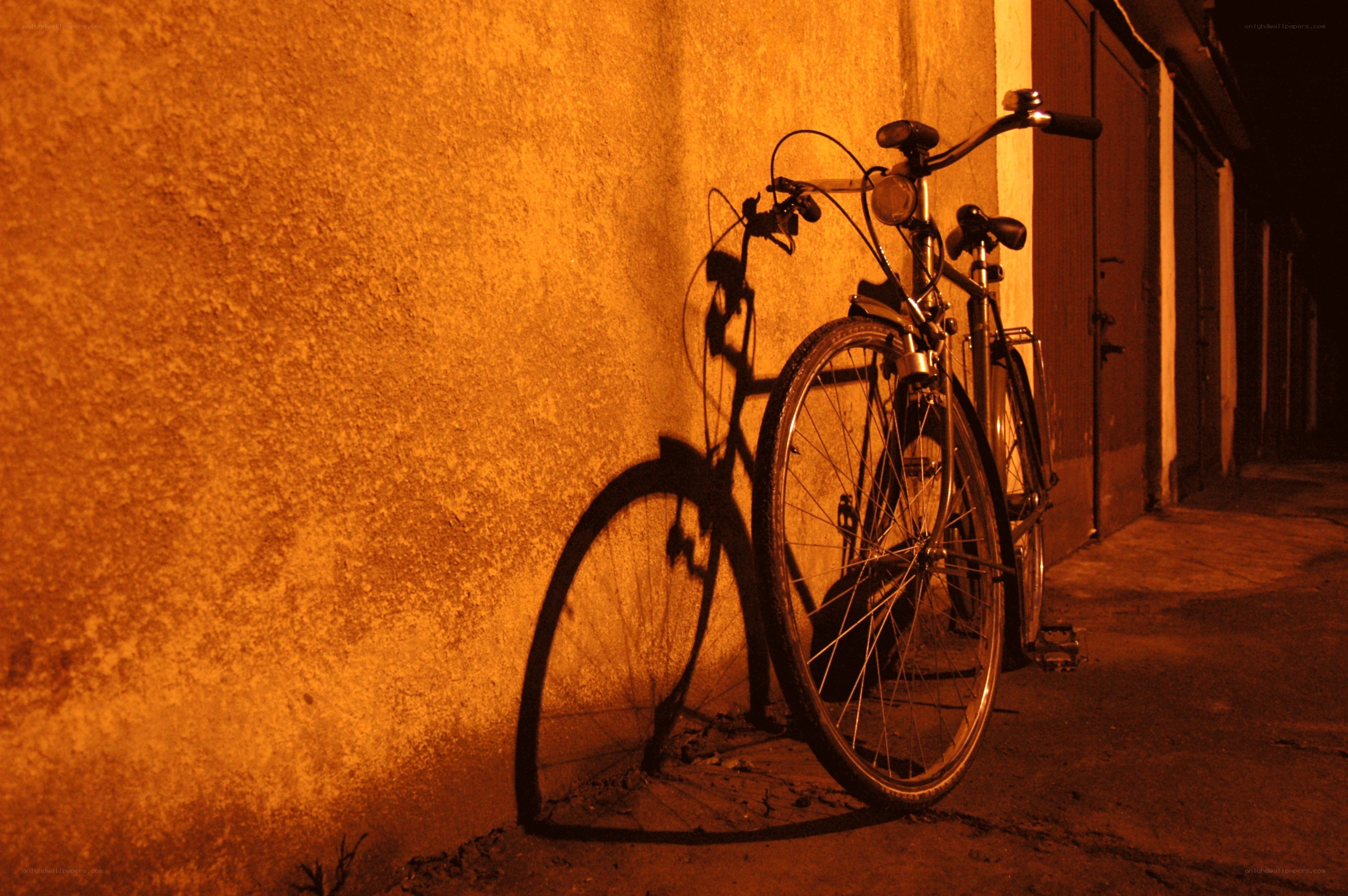 Bicycle at night against a wall