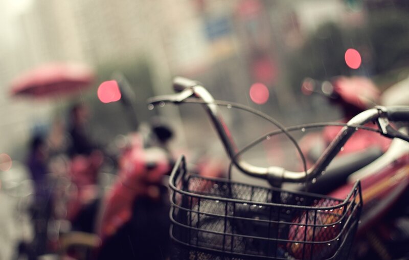 Bicycle basket in rainy city