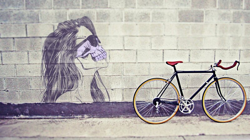 Bicycle beside skull mural