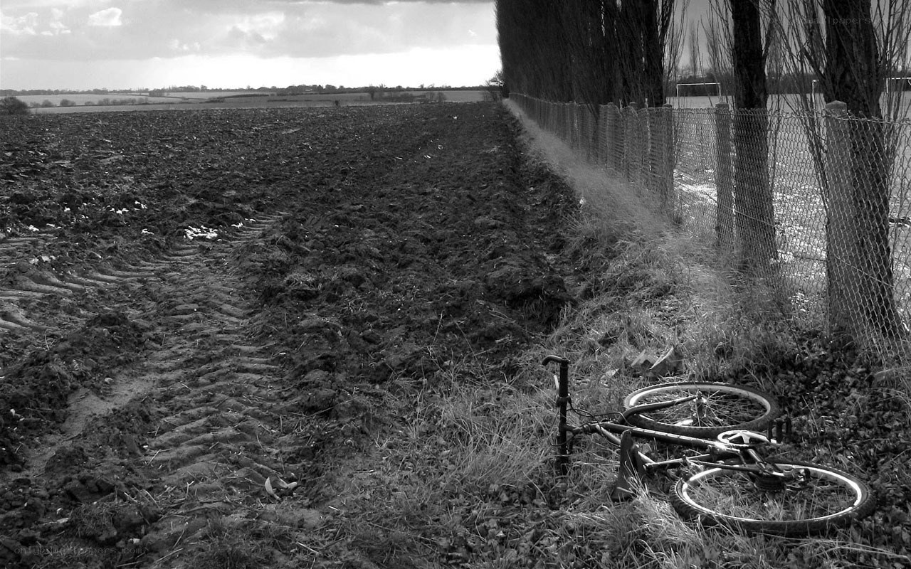 Bicycle in a plowed field