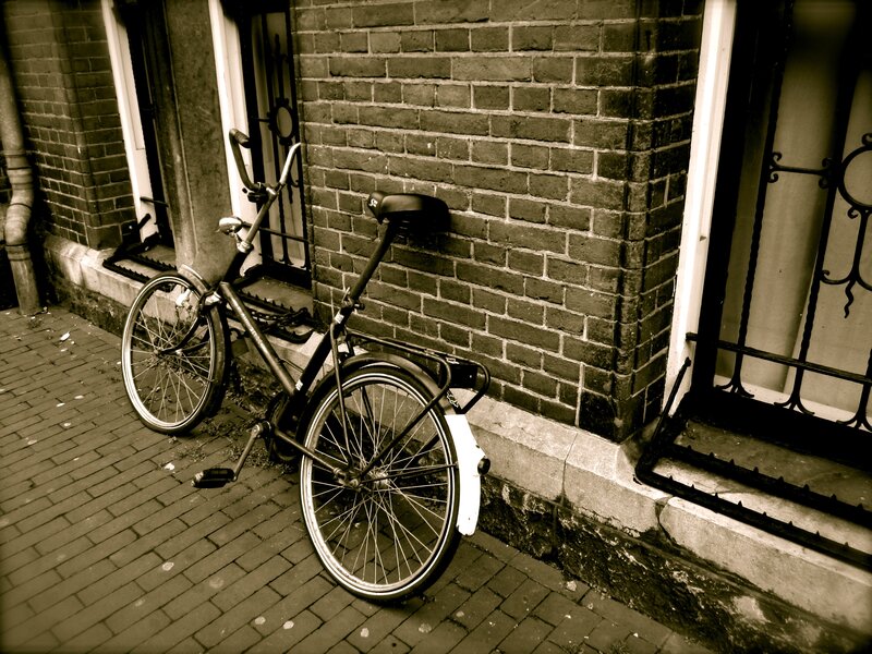 Bicycle leaning against a brick wall